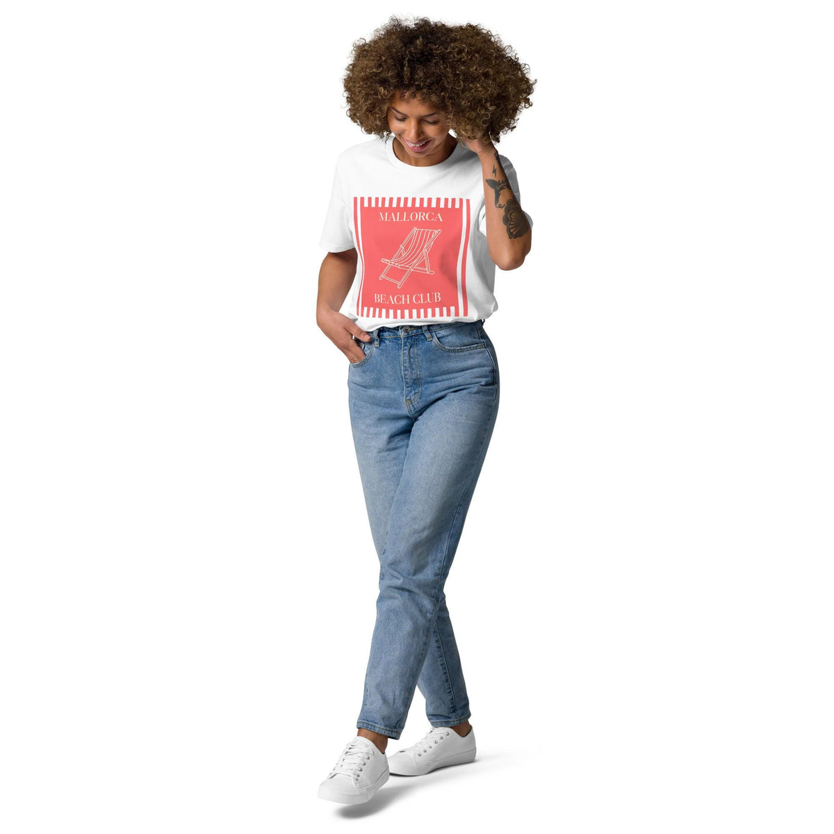 Mallorca Beach Club T-shirt in white, full-length view on a model with blue jeans.