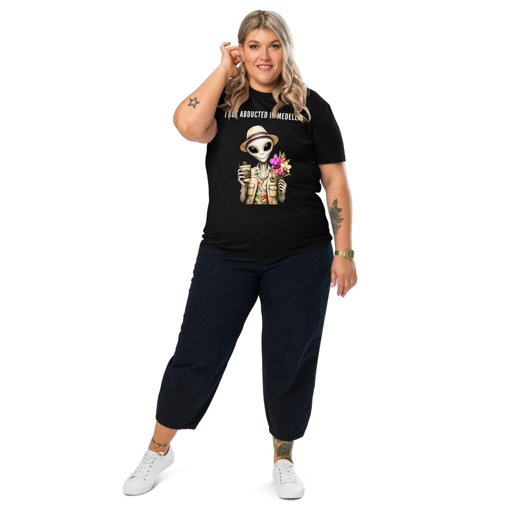 I Got Abducted in Medellin alien T-shirt in black, full-length view on a model with black trousers.