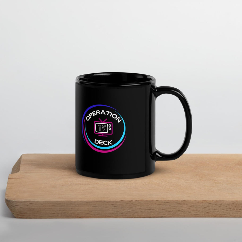 Black Operation Deck gaming mug circular logo side on a wooden shelf.