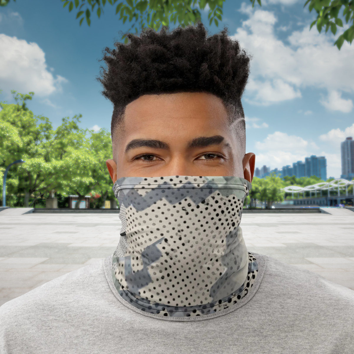 Urban Concrete 9 neck gaiter worn over the nose and mouth at a skatepark, front view.