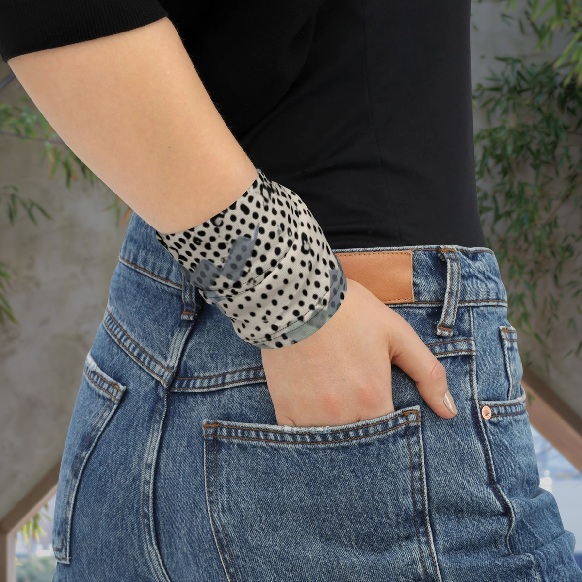 Urban Concrete 9 neck gaiter wrapped around the wrist beside blue jeans.