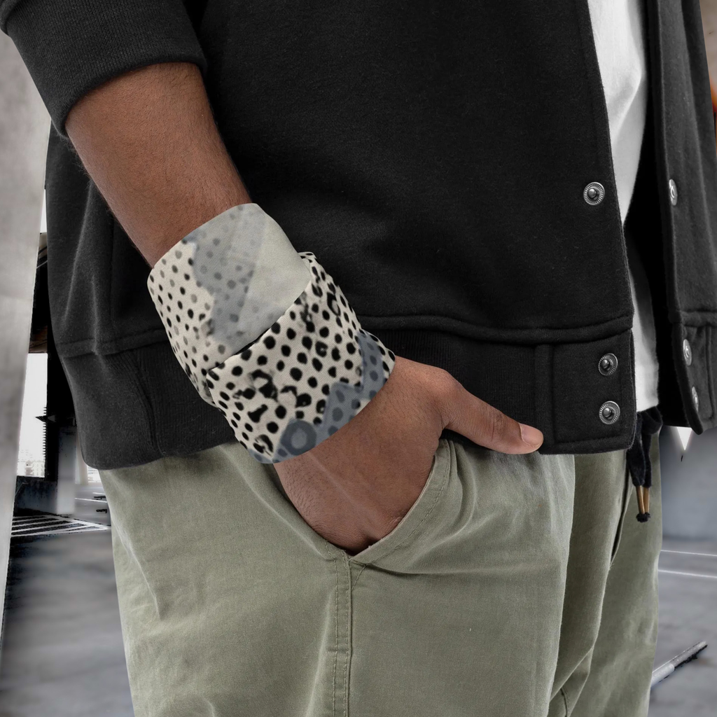 Urban Concrete 9 neck gaiter wrapped around the wrist beside a black jacket.