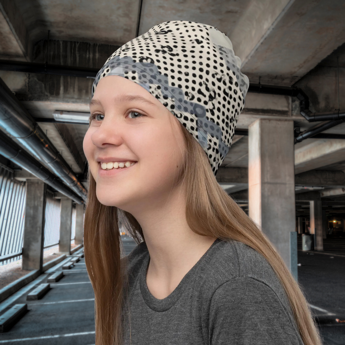 Urban Concrete 9 neck gaiter worn as a beanie in a concrete building, three-quarter view.