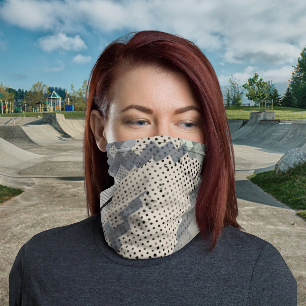 Urban Concrete 9 neck gaiter worn as a face covering at a skatepark, three-quarter view.