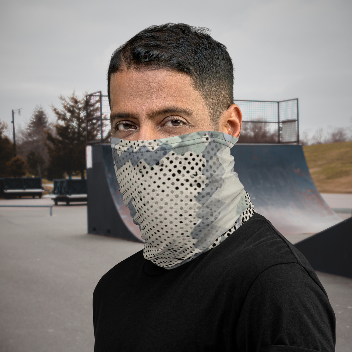 Urban Concrete 9 neck gaiter worn as a face covering with a black T-shirt at a skatepark.