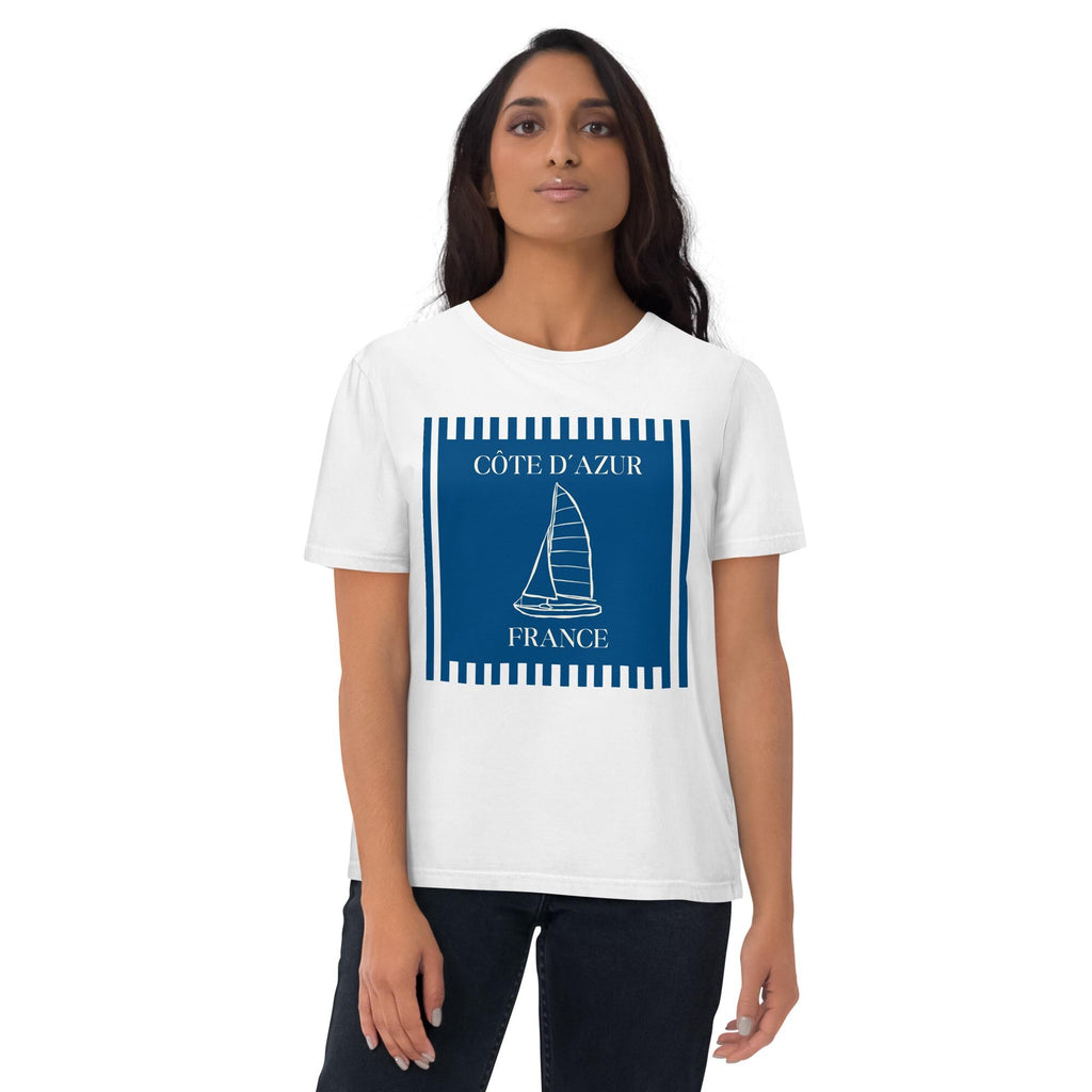 Côte d'Azur sailboat T-shirt in white, worn by a model with dark trousers, front view.