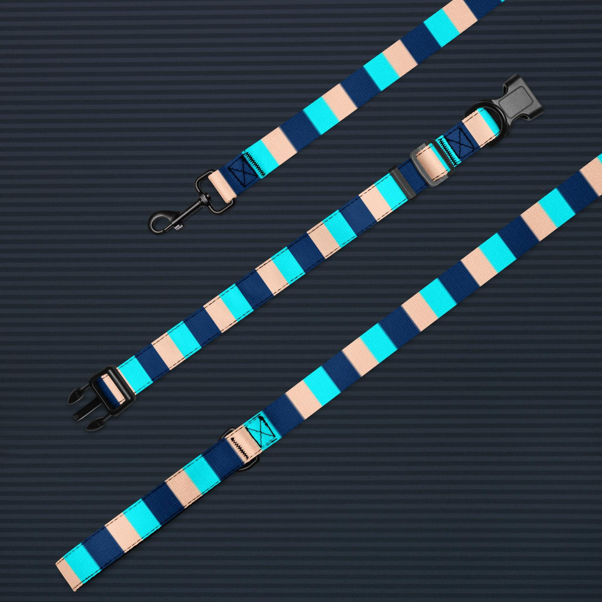 Blue Stripe dog collar and leash set laid out on a dark background to show the collar, leash and padded handle.