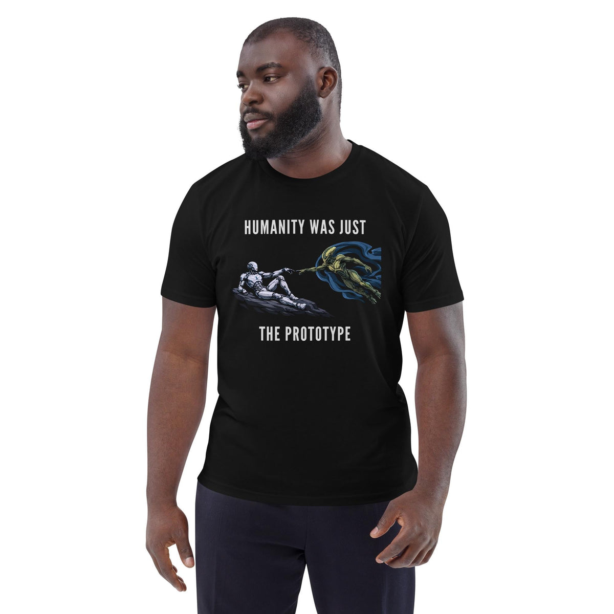 Humanity Prototype AI alien T-shirt in black, worn by a model with dark trousers, three-quarter view.