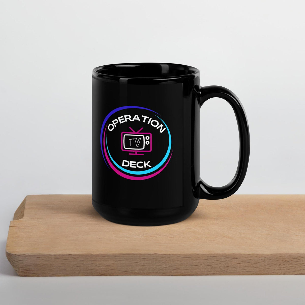 Black Operation Deck gaming mug tall mug circular logo side on a wooden shelf.