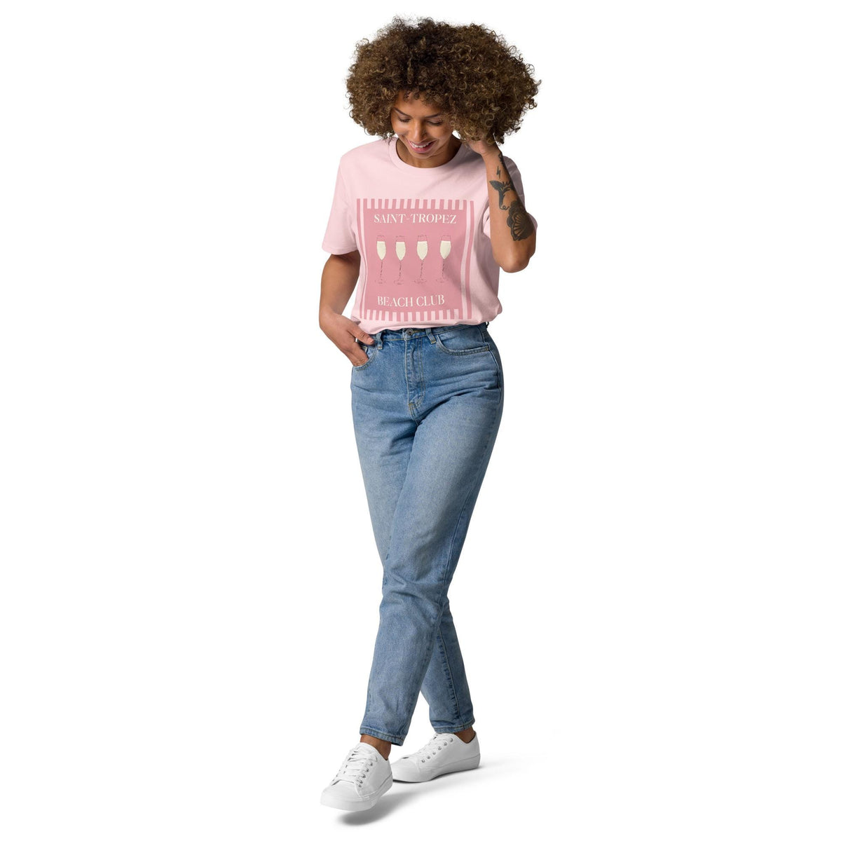 Saint-Tropez Beach Club T-shirt in pink, full-length view on a model with blue jeans.