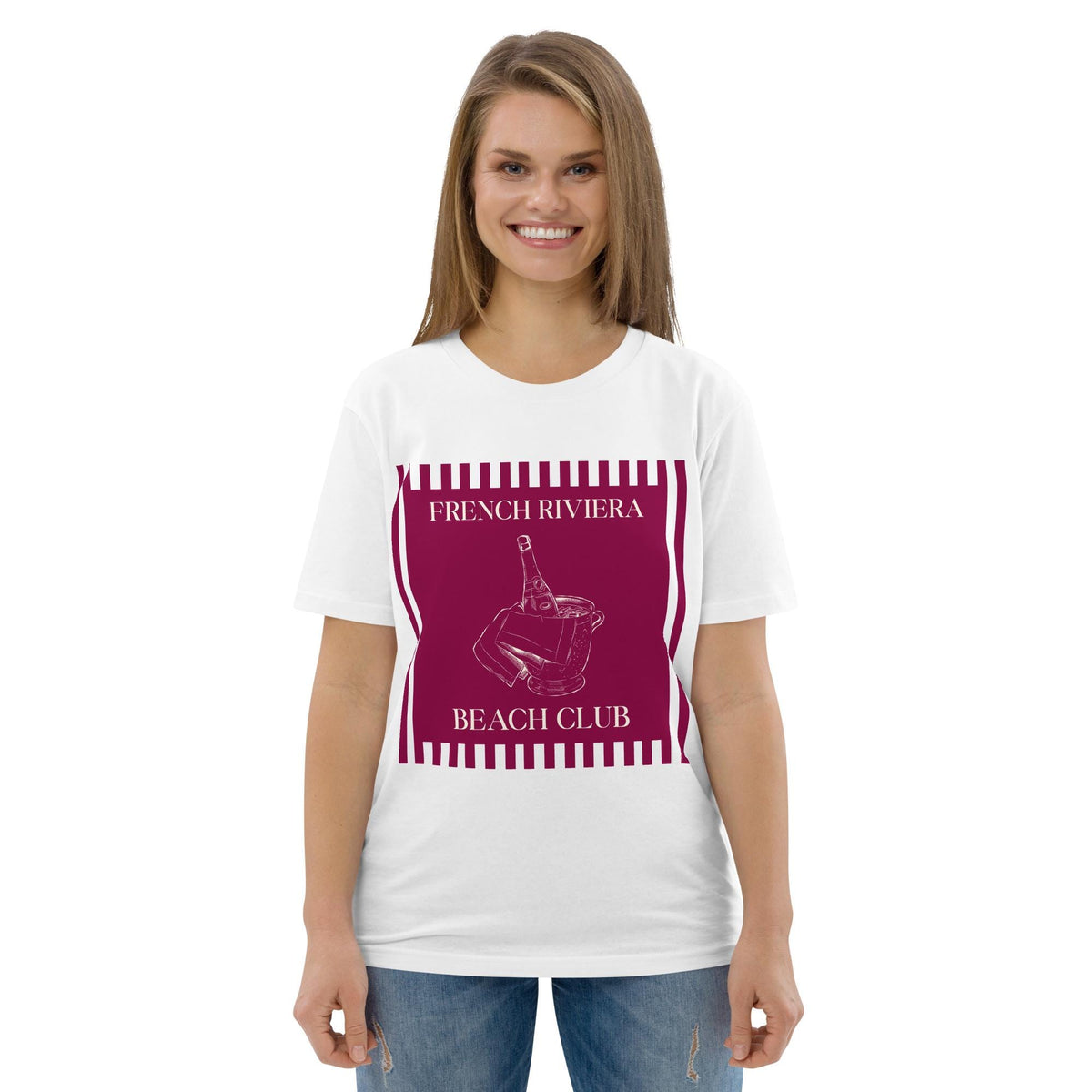 French Riviera Beach Club T-shirt in white, worn by a model with jeans, front view on white.