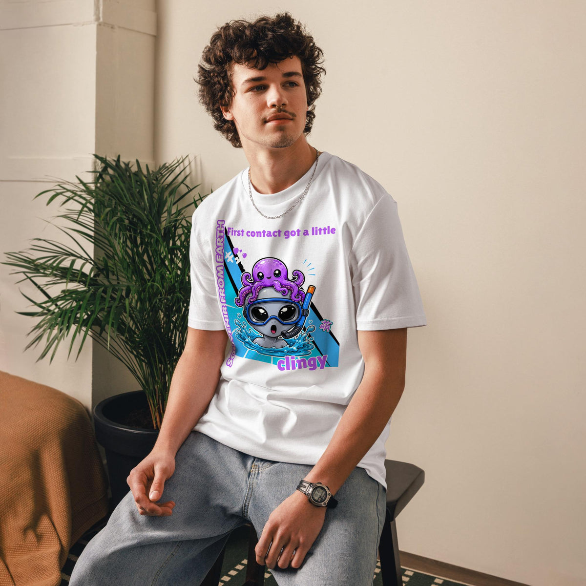 Alien Octopus snorkeling T-shirt in white, worn by a seated model indoors.