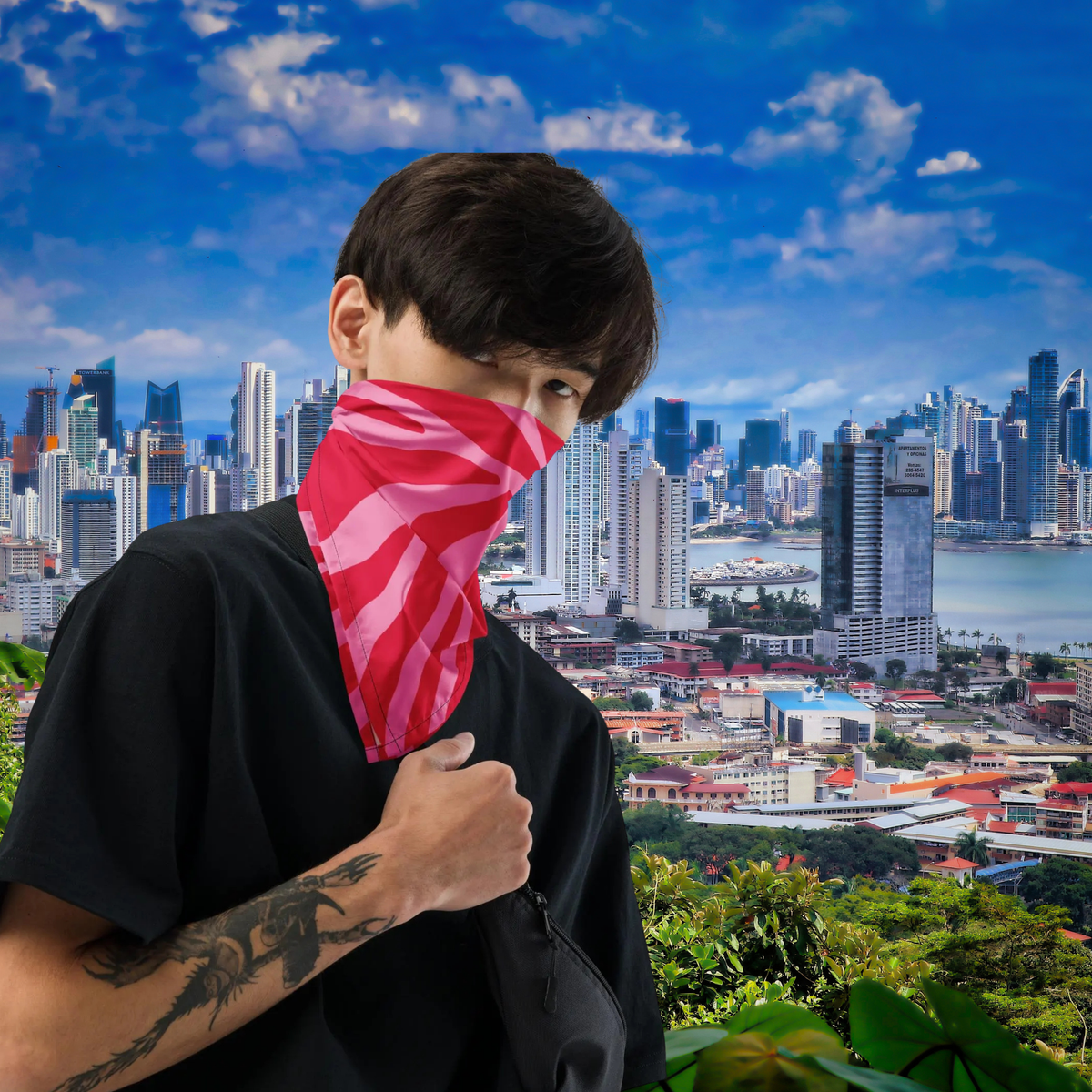 Pink Zebra bandana worn over the nose and mouth against a city skyline.