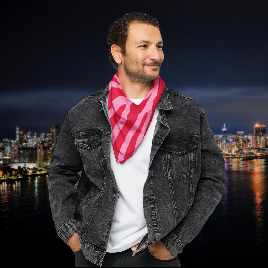 Pink Zebra bandana worn as a neck scarf with a dark denim jacket at night.
