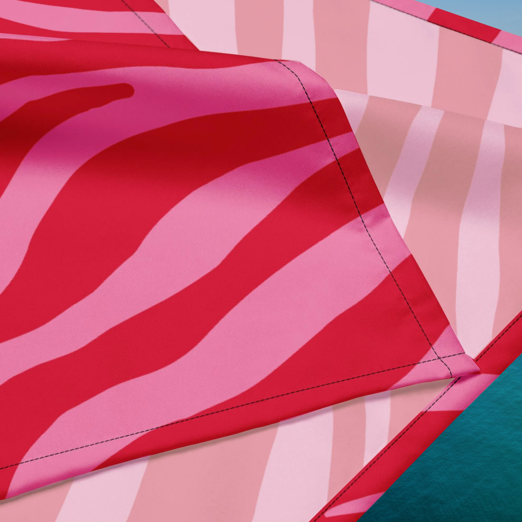 Pink Zebra bandana close-up of the printed fabric and double-folded stitched edge.