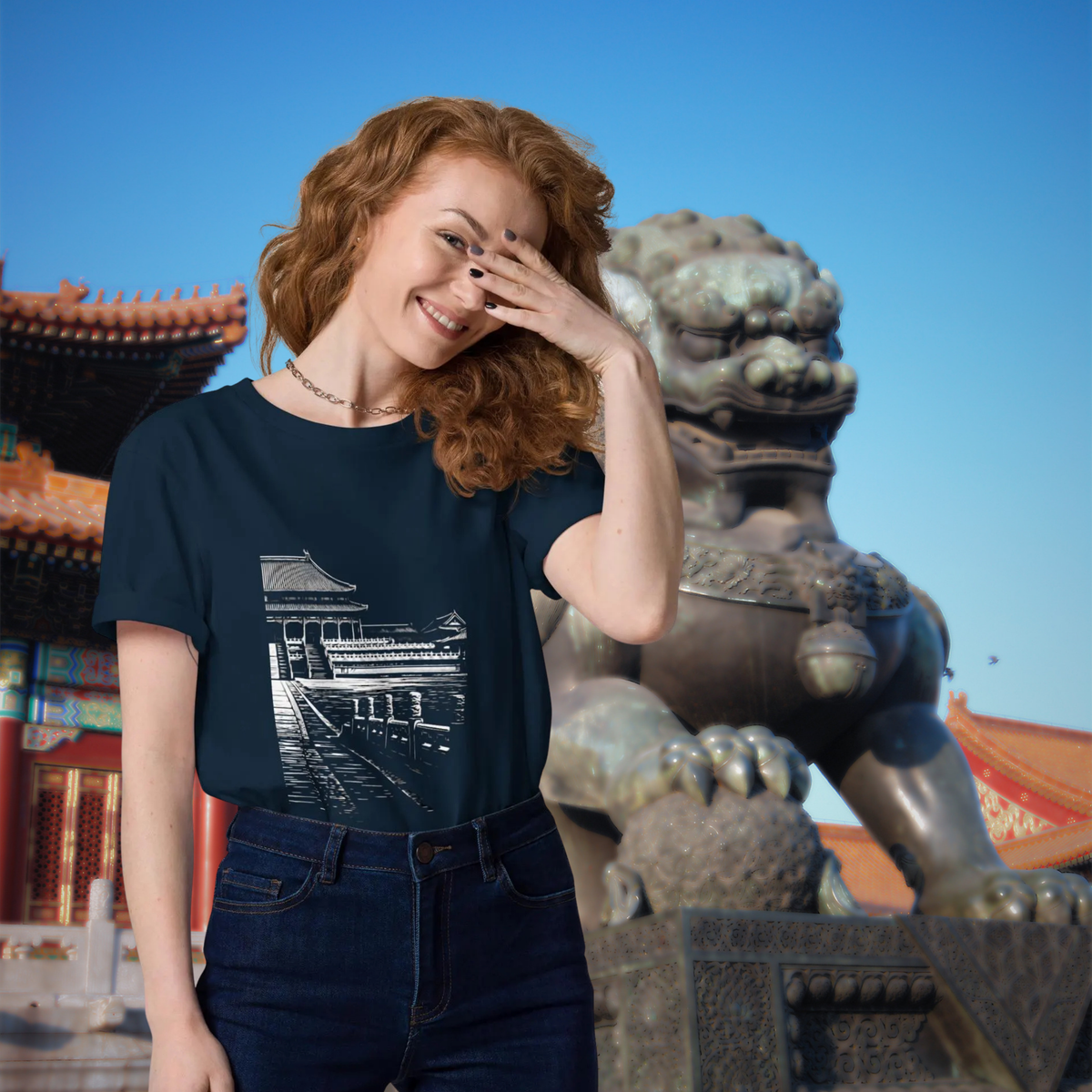 Forbidden City T-shirt in navy, worn by a model beside a stone guardian lion.