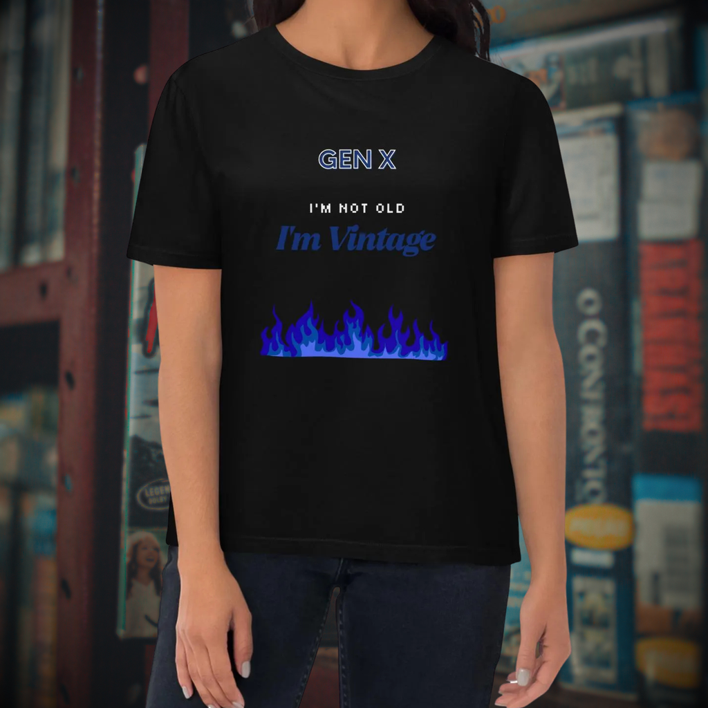 Gen X Blue Flame Vintage T-shirt in black, torso view against a retro media backdrop.