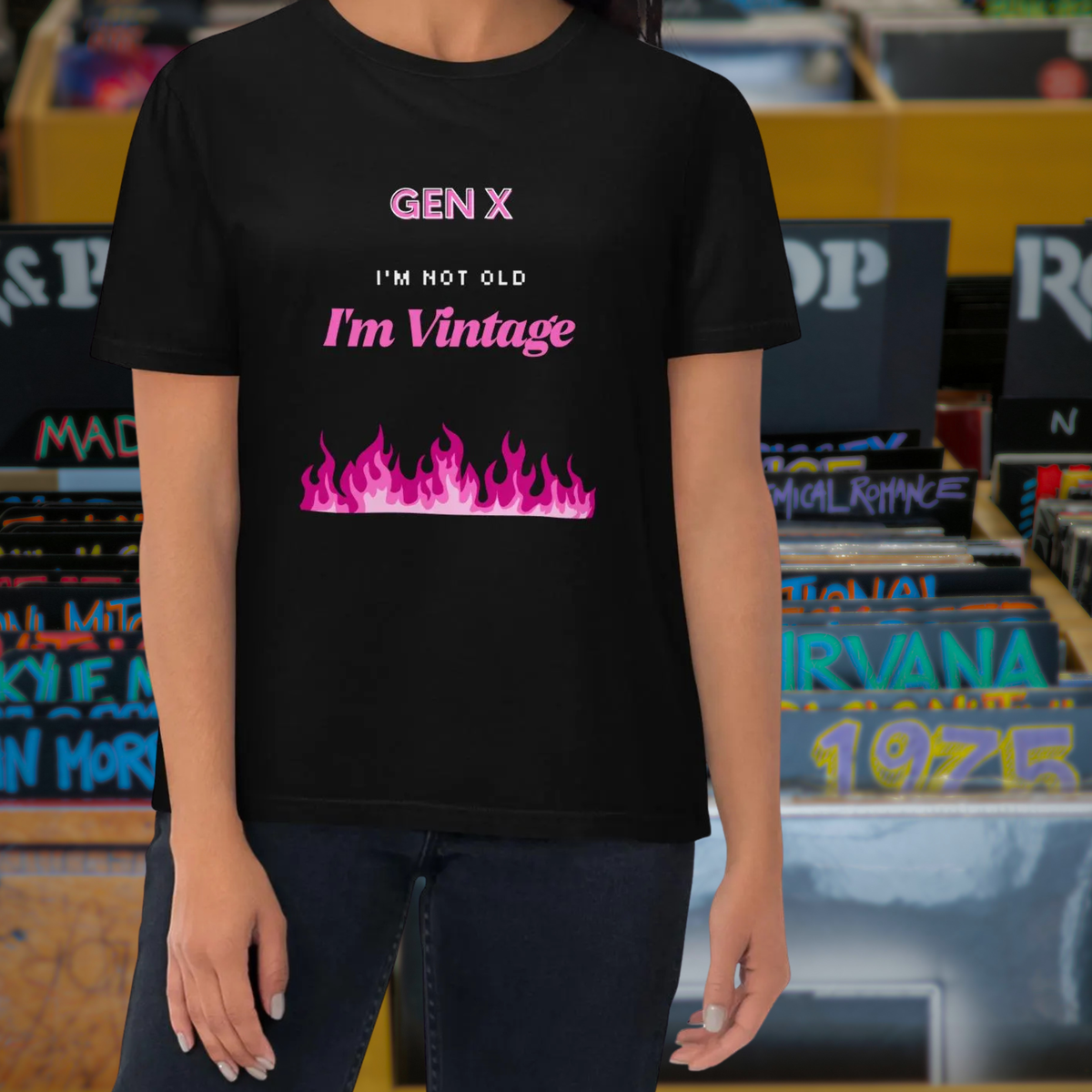 Gen X Pink Flame Vintage T-shirt in black, torso view against a retro music backdrop.