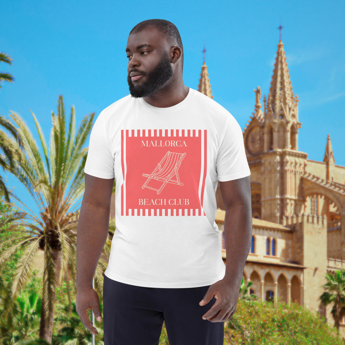 Mallorca Beach Club T-shirt in white, worn by a model against palm trees and cathedral architecture.