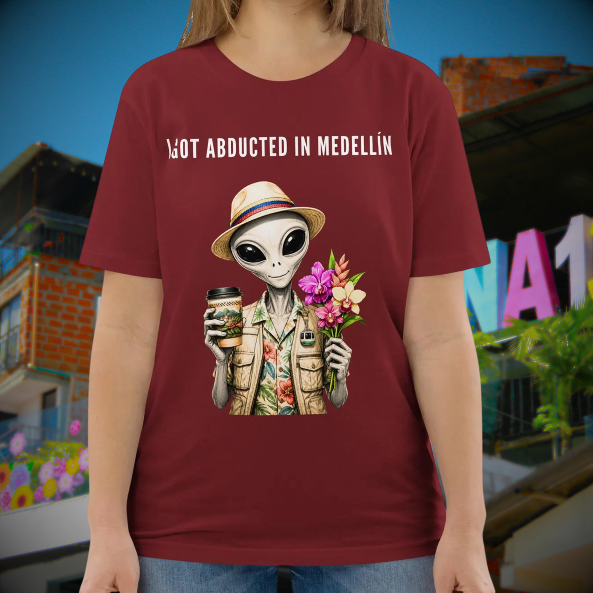 I Got Abducted in Medellin alien T-shirt in burgundy, torso view showing the alien and flowers.