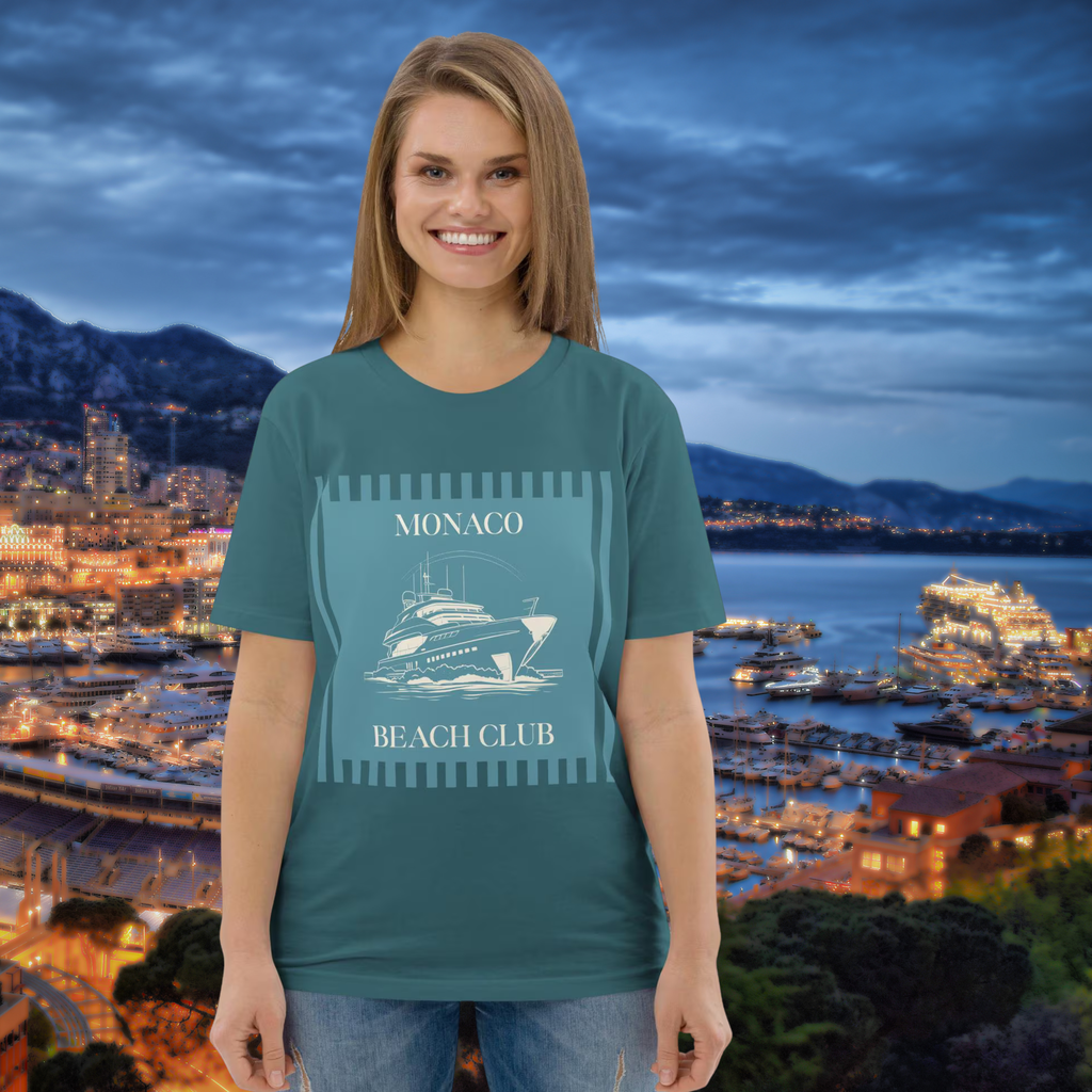 Monaco Beach Club T-shirt in teal, worn by a model against an illuminated harbour.