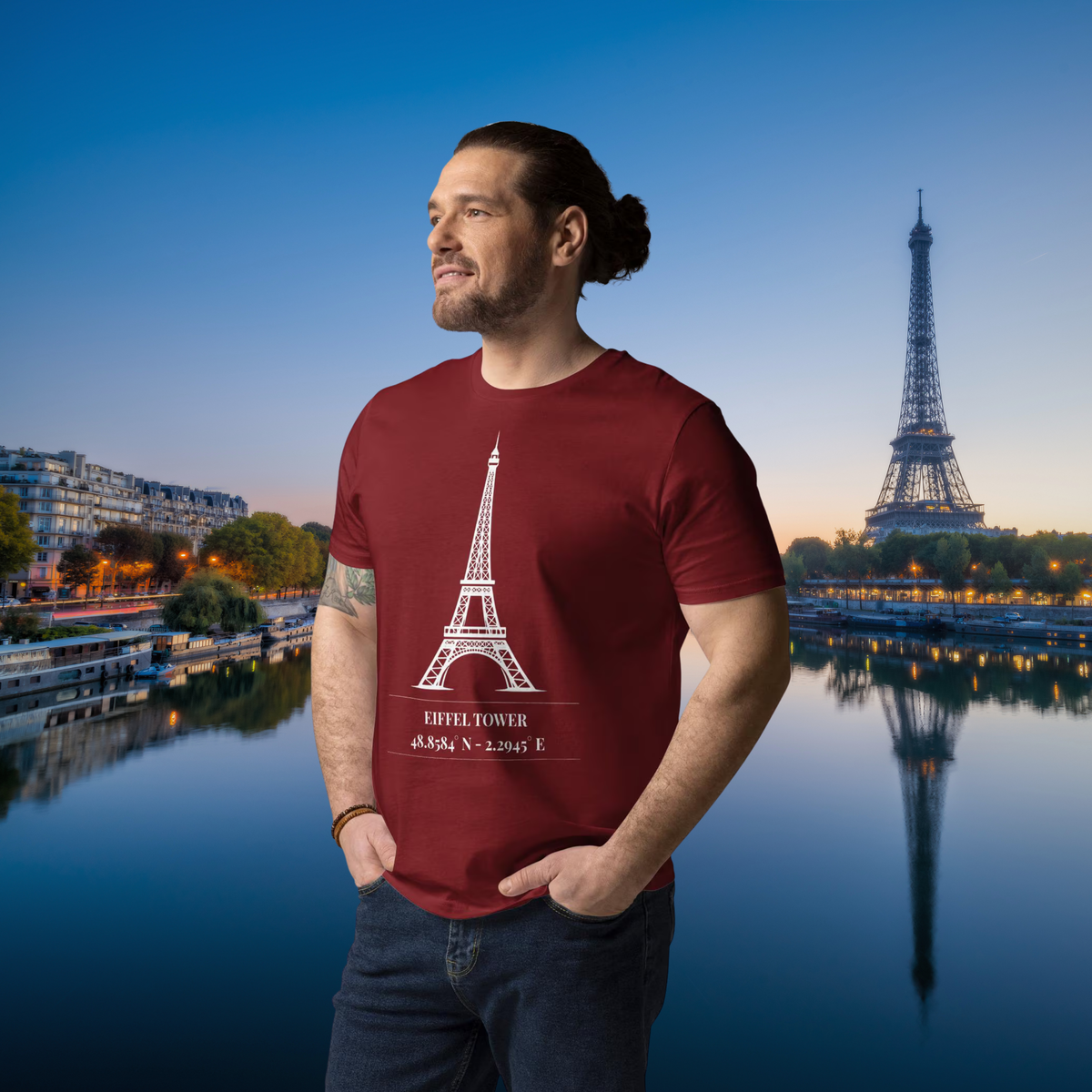 Man wearing the burgundy Eiffel Tower coordinates T-shirt beside the Seine.