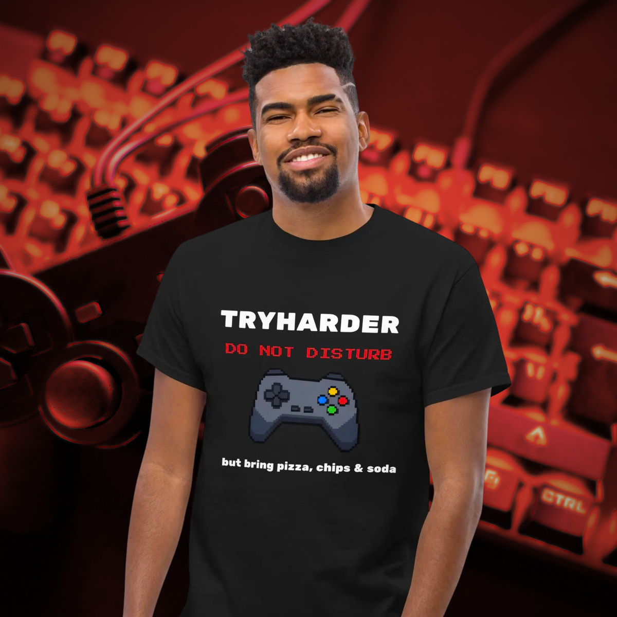Tryharder gamer T-shirt in black, worn by a smiling model against a red gaming backdrop.