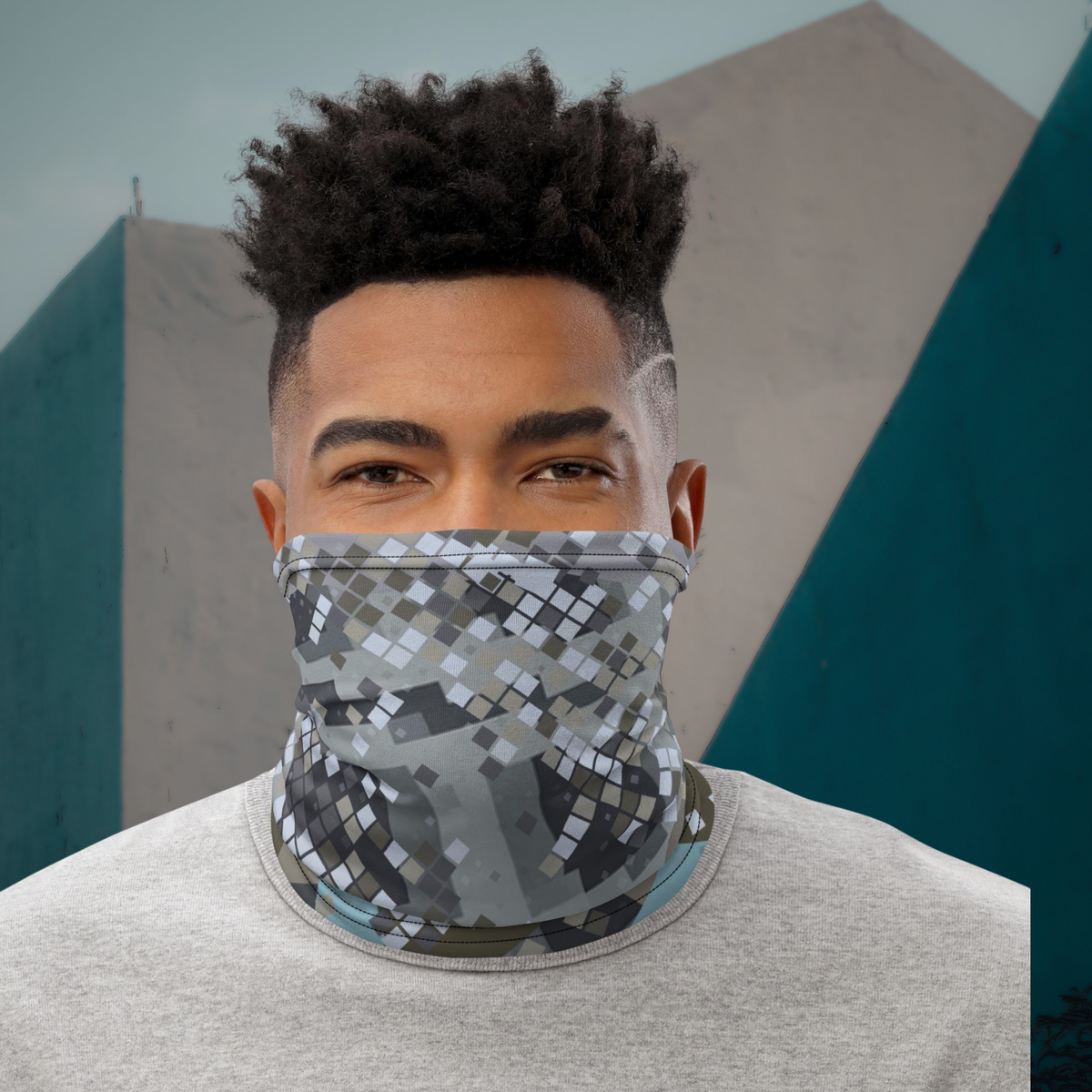 Urban Concrete 2 neck gaiter worn over the nose and mouth against an angular wall, front view.