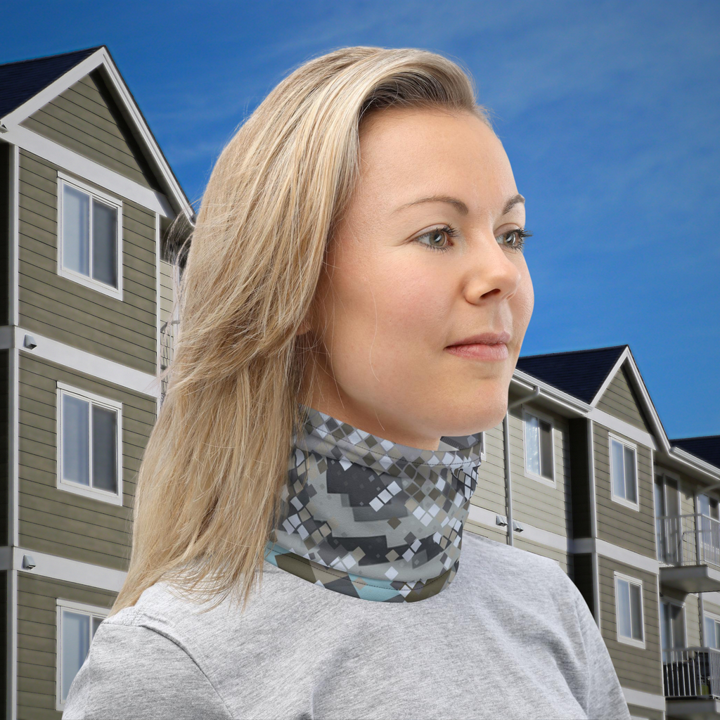 Urban Concrete 2 neck gaiter worn as a neck warmer outside a row of houses.