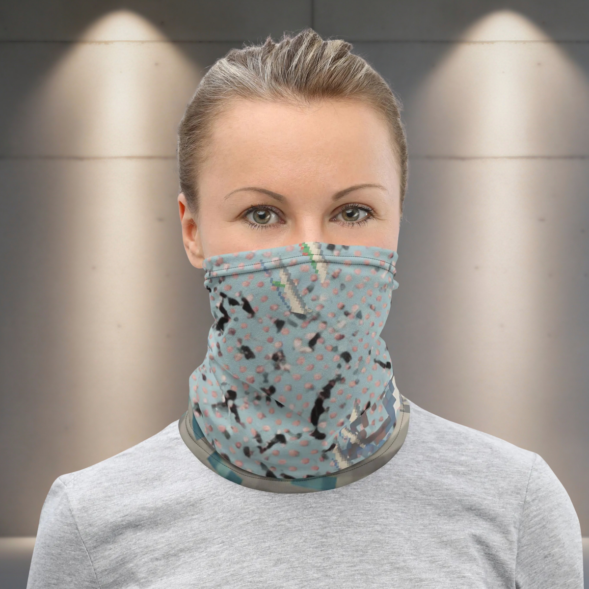 Urban Concrete 3 neck gaiter worn as a face covering indoors with a grey top, front view.