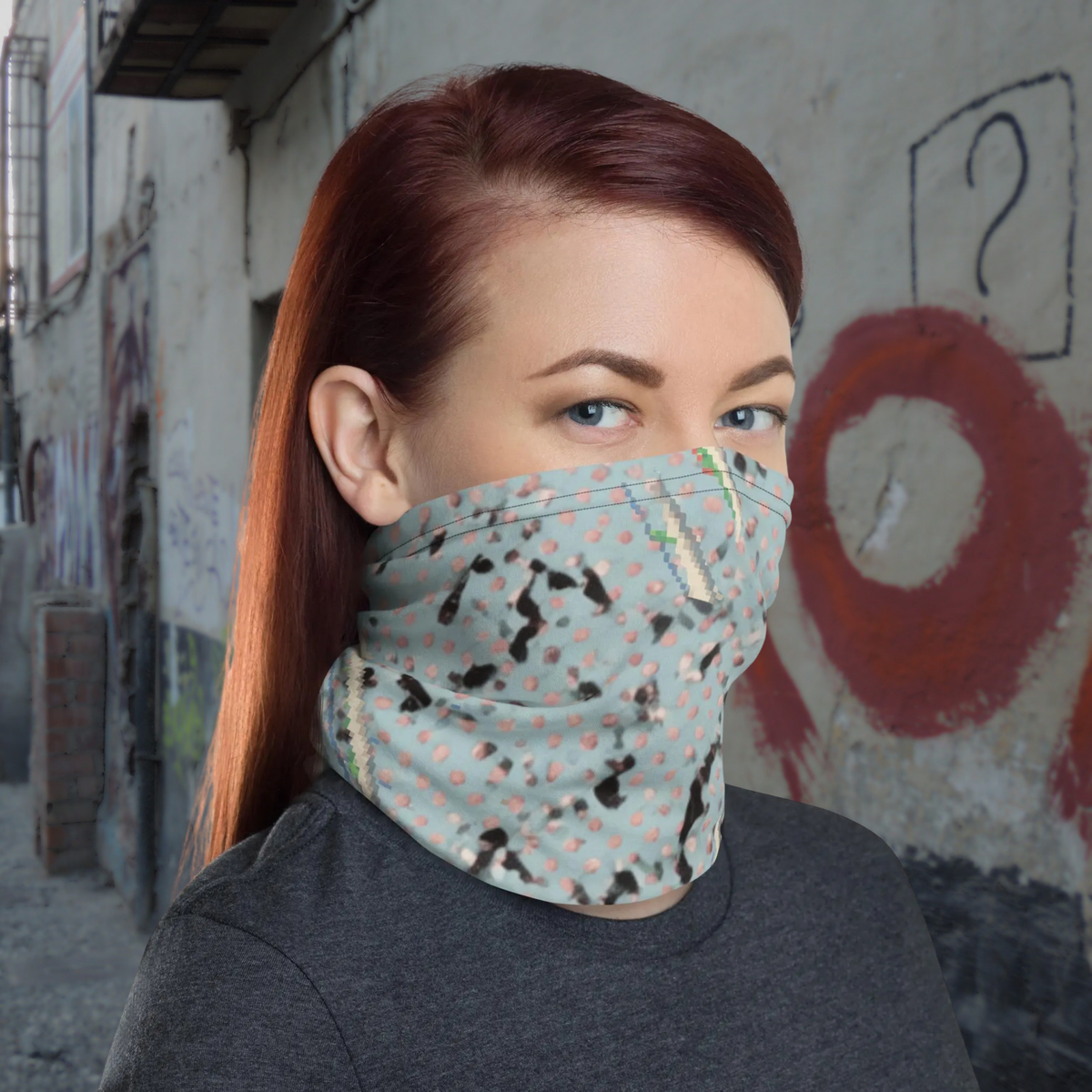 Urban Concrete 3 neck gaiter worn as a face covering against a graffiti-covered wall.