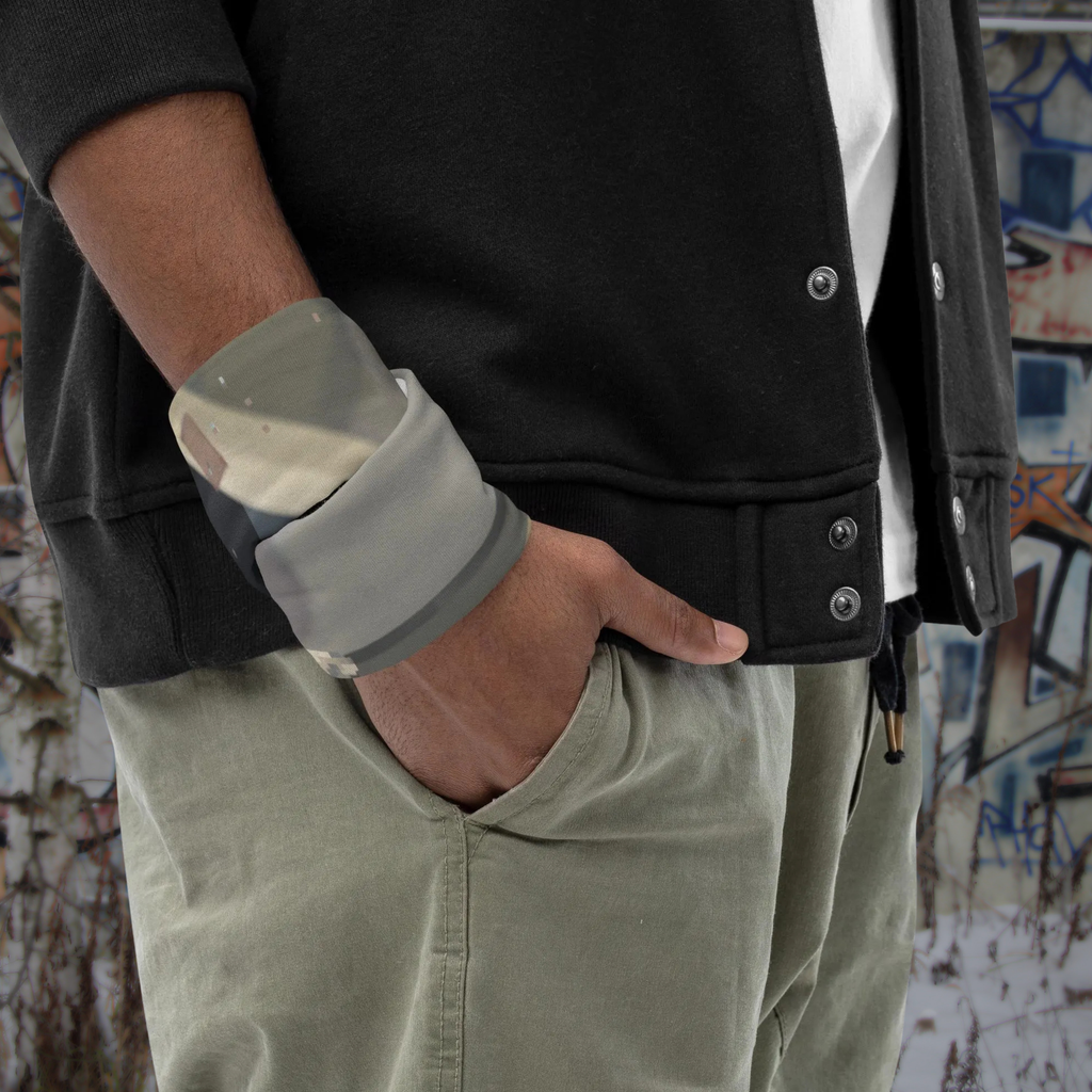 Urban Concrete 4 neck gaiter wrapped around the wrist beside a black jacket.