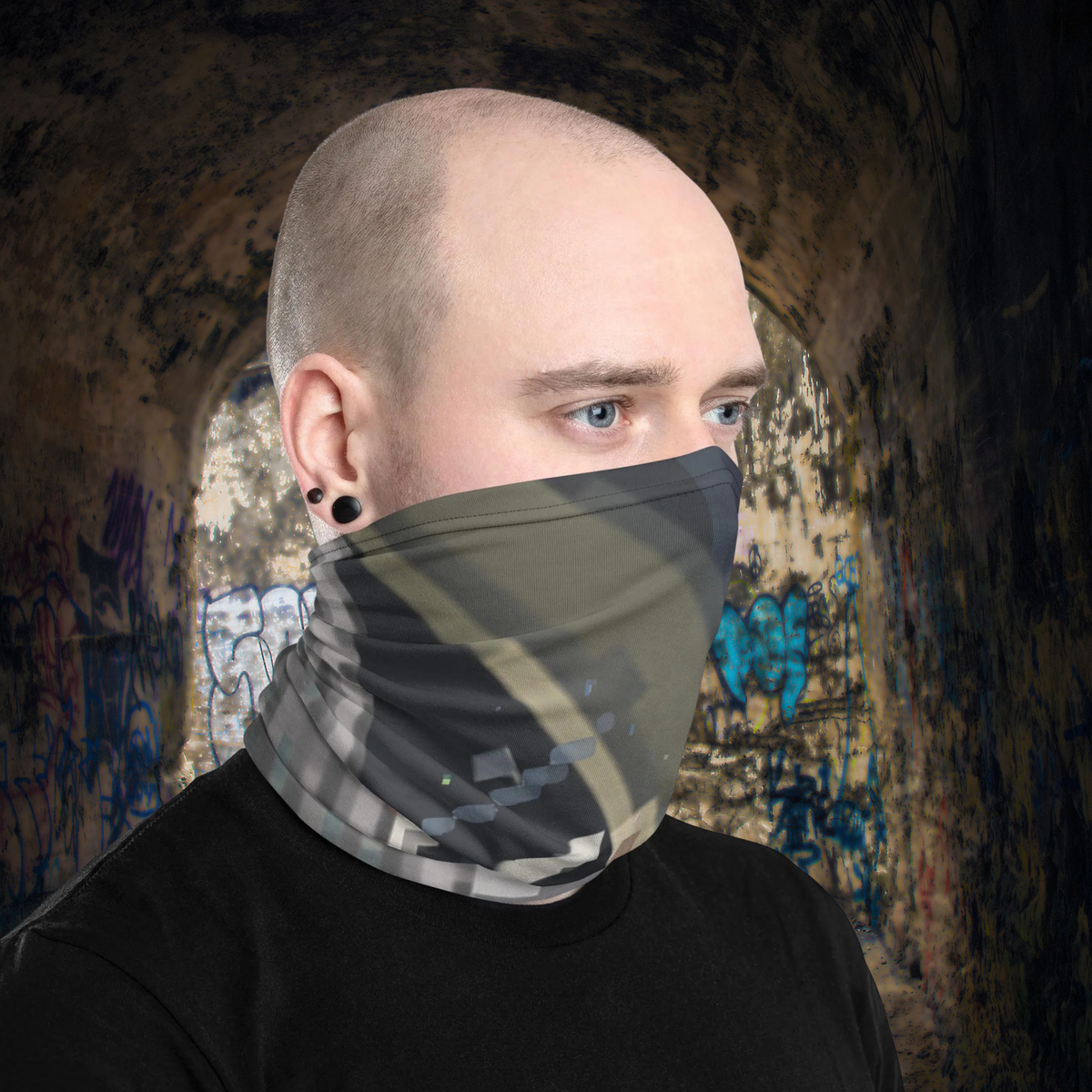 Urban Concrete 4 neck gaiter worn as a face covering in a graffiti-covered building.
