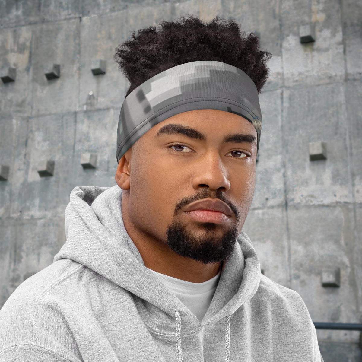 Urban Concrete 4 neck gaiter worn as a headband with a grey hoodie.