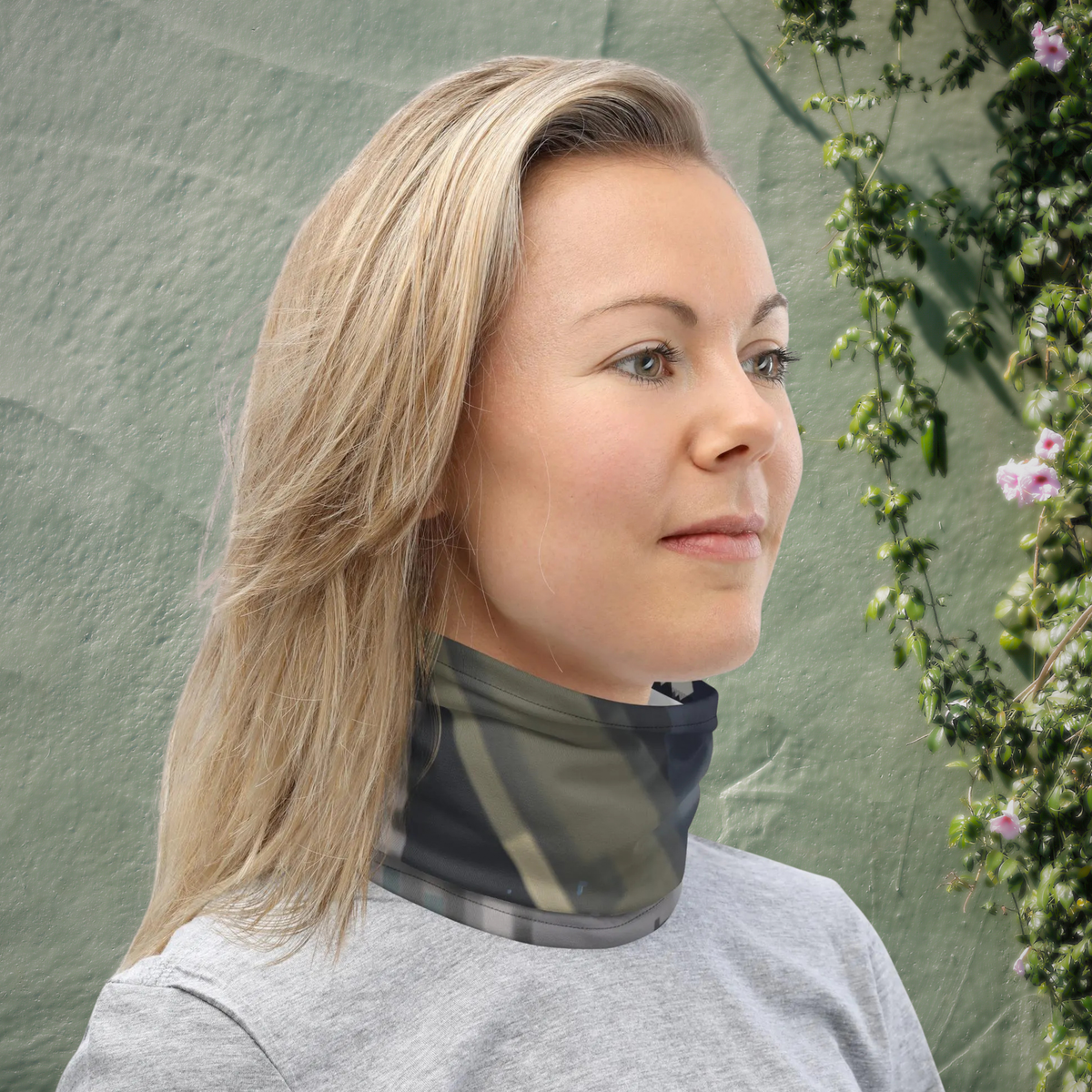 Urban Concrete 4 neck gaiter worn as a neck warmer against a green textured wall.