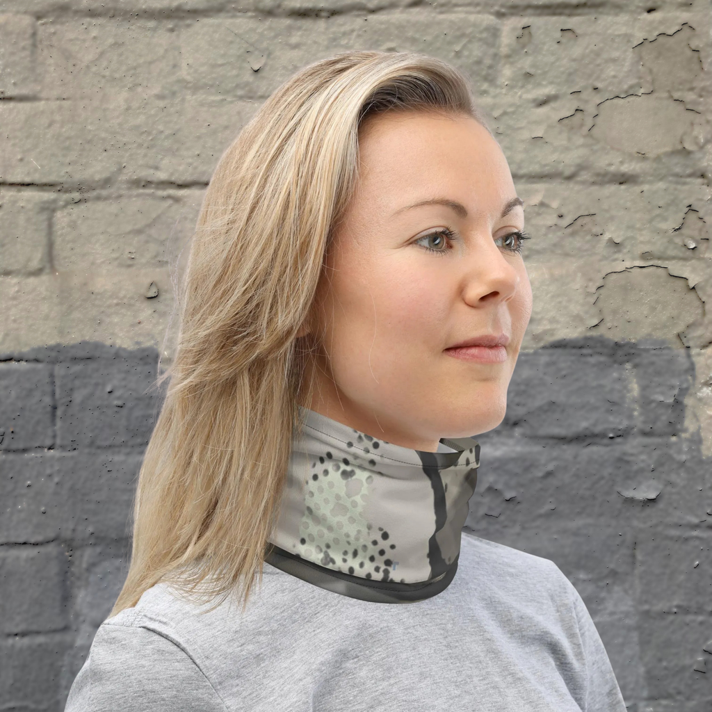 Urban Concrete 5 neck gaiter worn as a neck warmer against a stone wall.