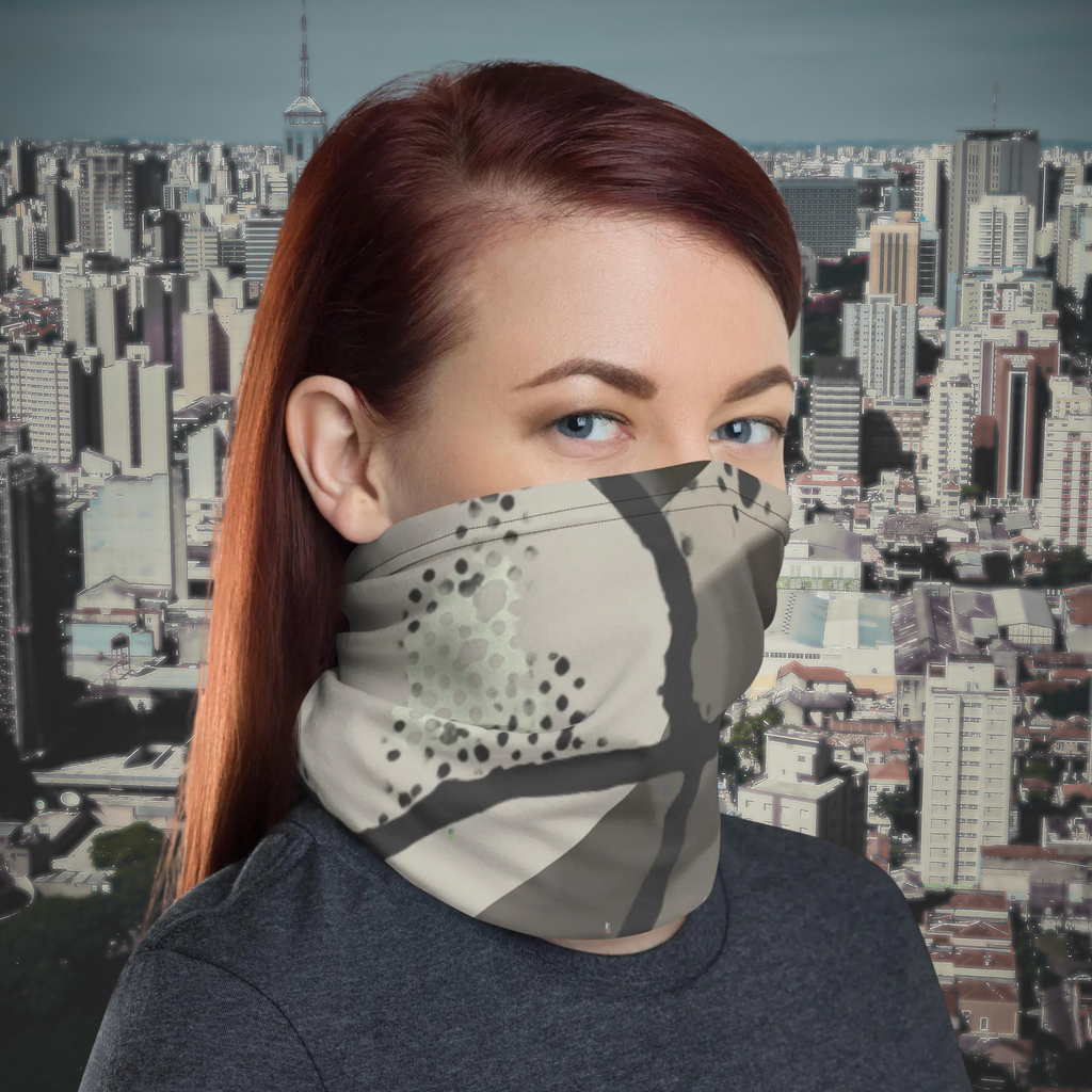 Urban Concrete 5 neck gaiter worn as a face covering against a city skyline.