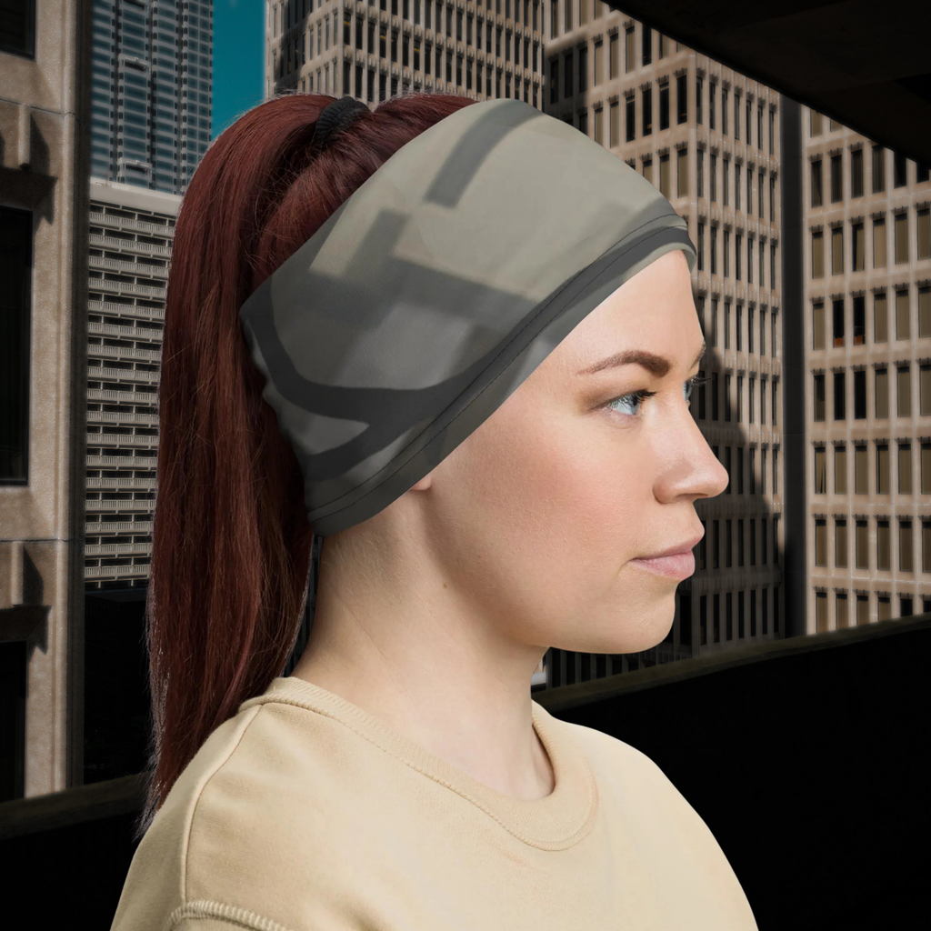 Urban Concrete 5 neck gaiter worn as a headband on a city street, side view.