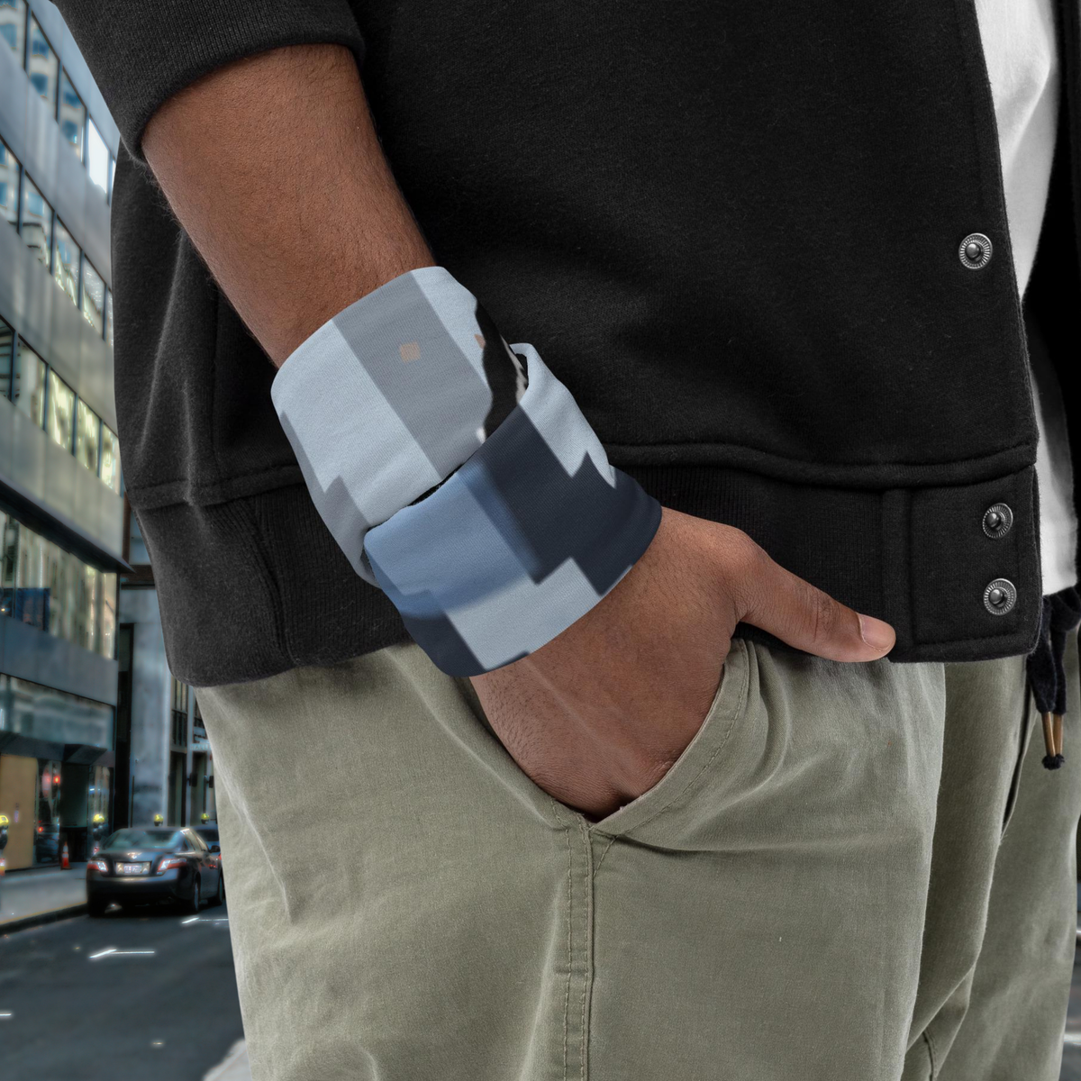 Urban Concrete 6 neck gaiter wrapped around the wrist beside a black jacket.