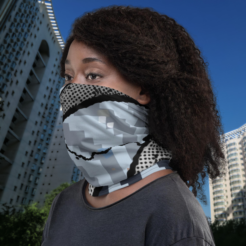 Urban Concrete 6 neck gaiter worn over the nose and mouth beside a city building.