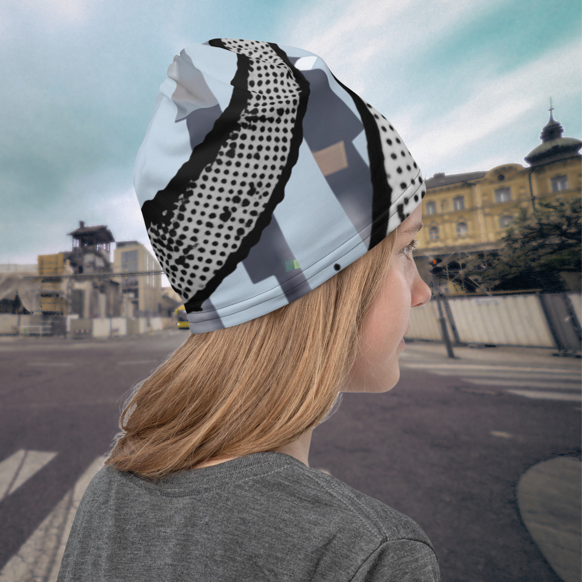 Urban Concrete 6 neck gaiter worn as a beanie in an urban square, rear side view.