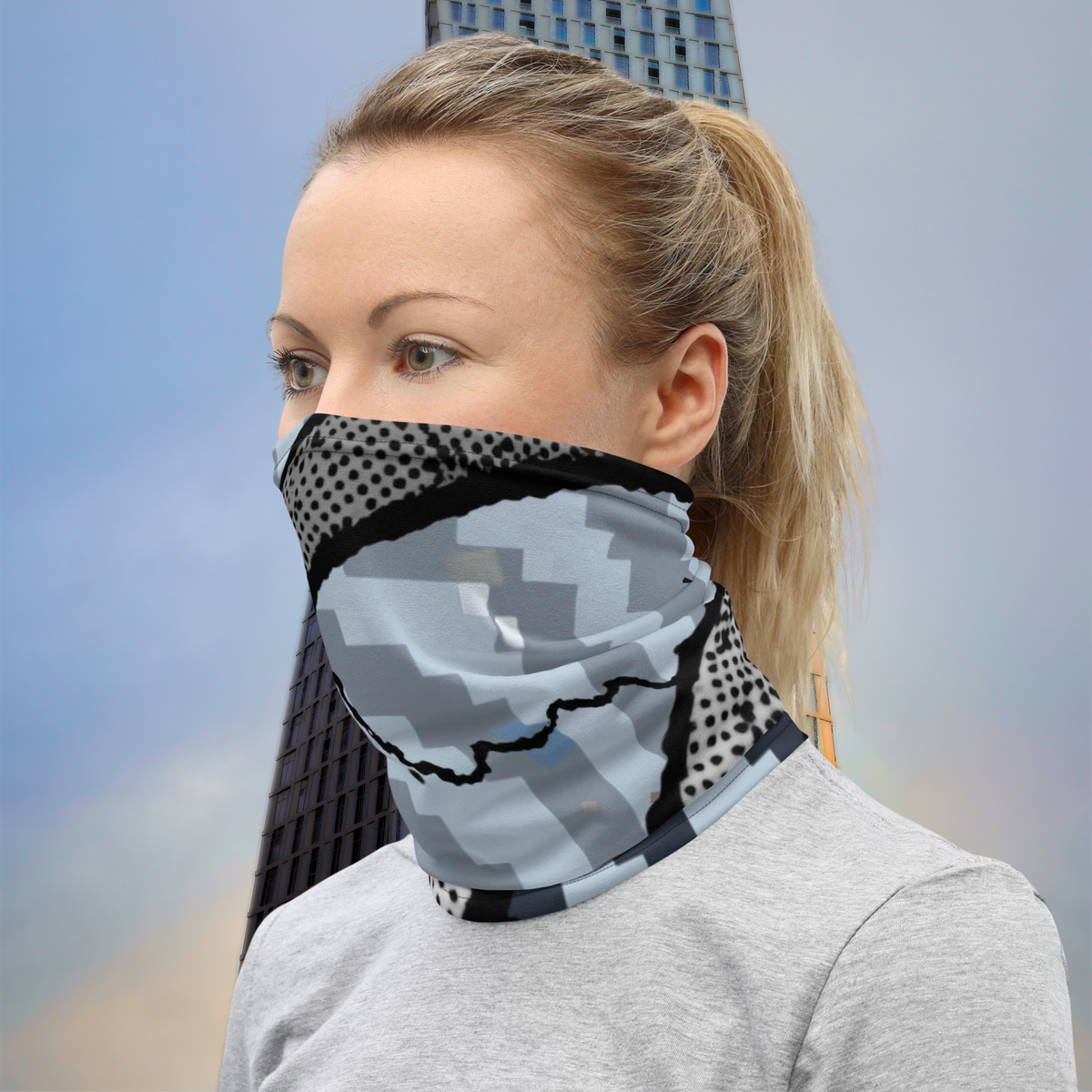 Urban Concrete 6 neck gaiter worn as a face covering outdoors with a grey top.