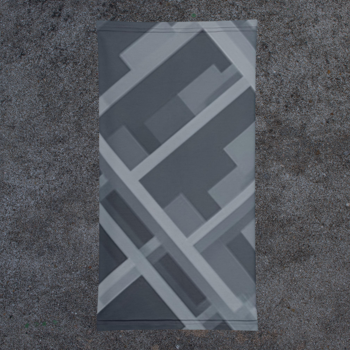 Urban Concrete 8 neck gaiter laid flat, showing dark grey blocks and intersecting angular lines.