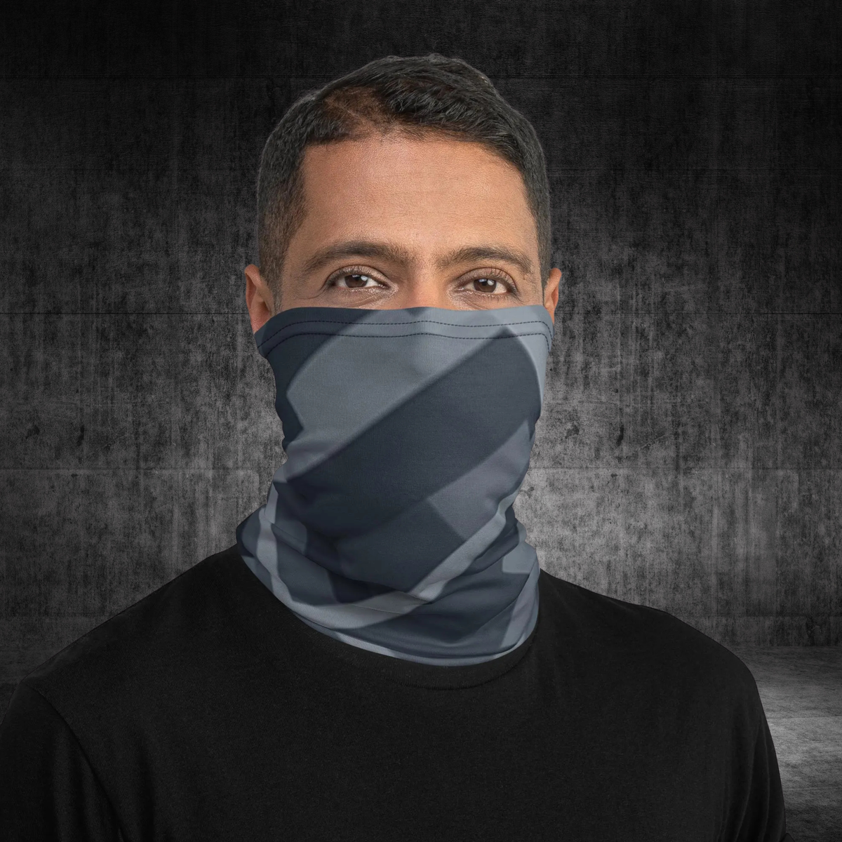 Urban Concrete 8 neck gaiter worn as a face covering with a black T-shirt against concrete.