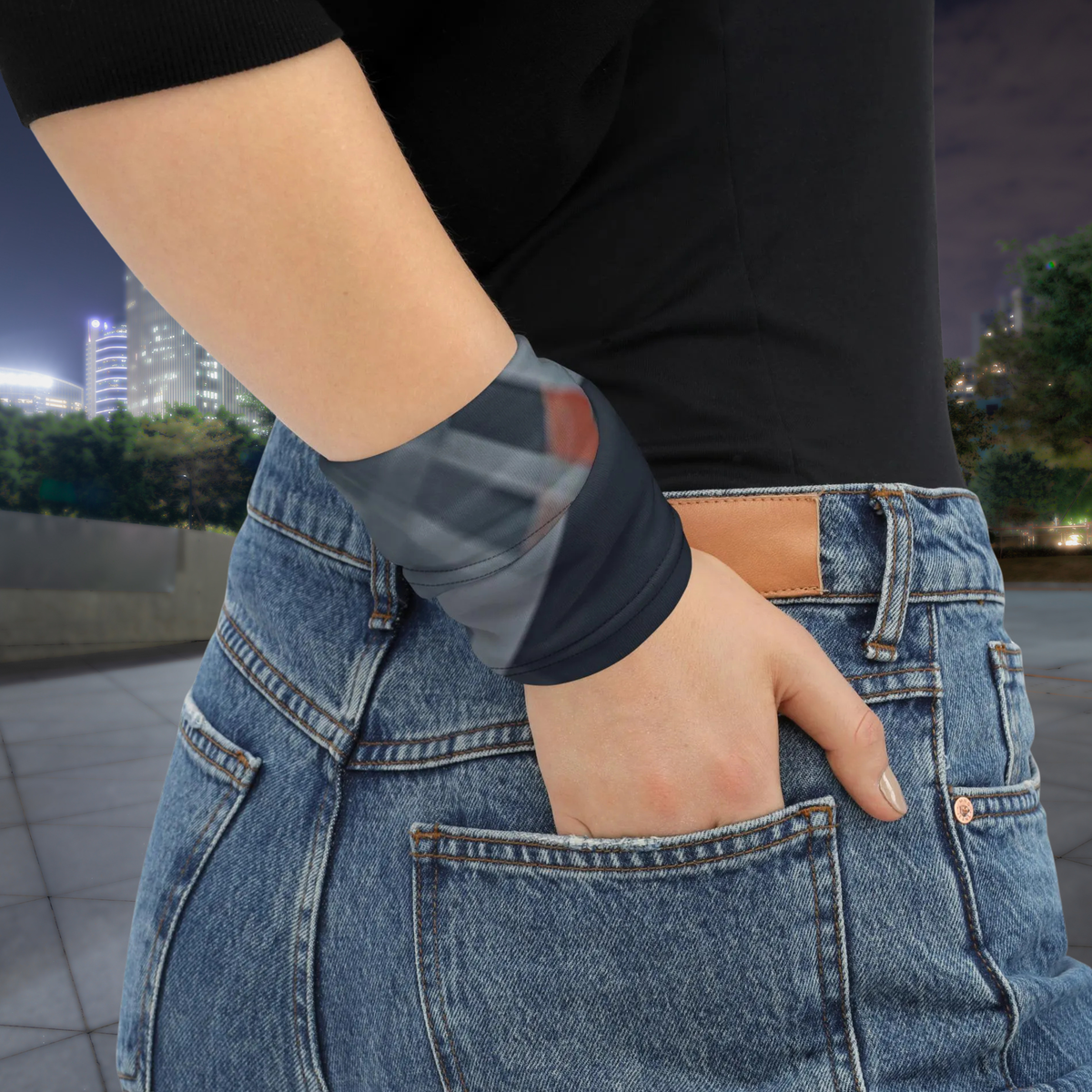 Urban Concrete 8 neck gaiter wrapped around the wrist beside blue jeans.