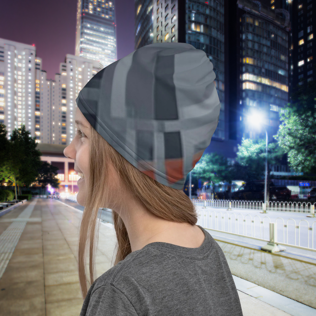 Urban Concrete 8 neck gaiter worn as a beanie in a city at night, rear side view.