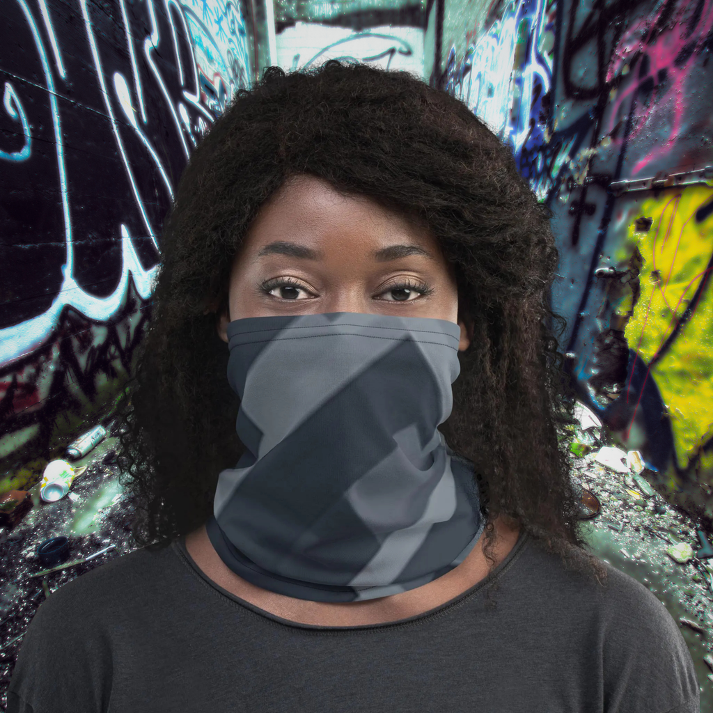 Urban Concrete 8 neck gaiter worn over the nose and mouth against a graffiti wall.