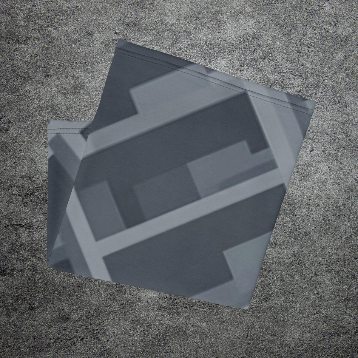 Urban Concrete 8 neck gaiter folded to show overlapping dark grey and slate geometric shapes.