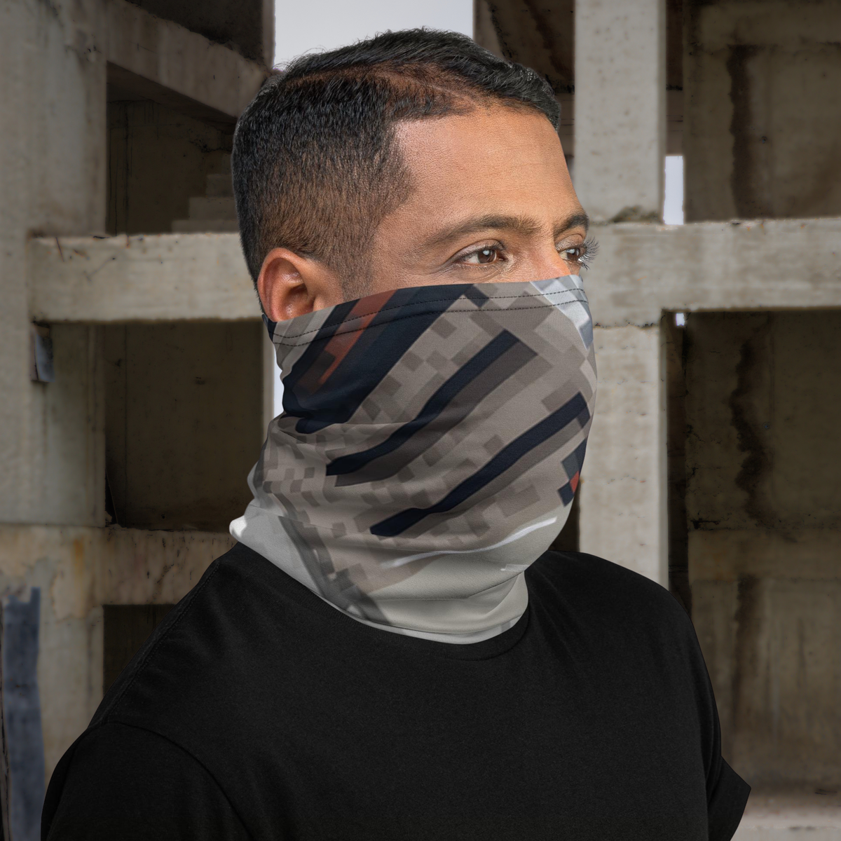 Urban Concrete 10 neck gaiter worn over the face, side view in a concrete building.