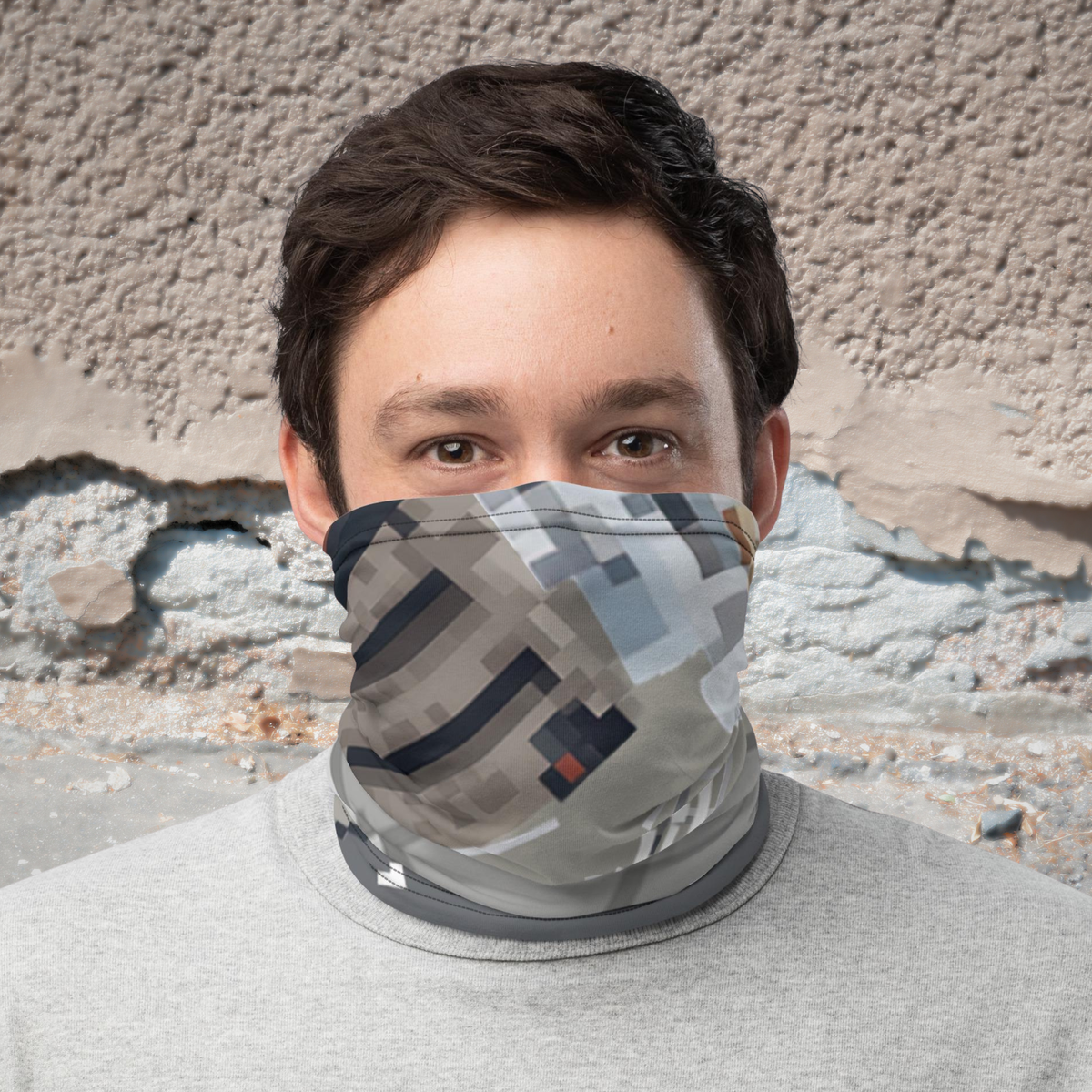 Urban Concrete 10 neck gaiter worn over the nose and mouth against a textured stone wall.